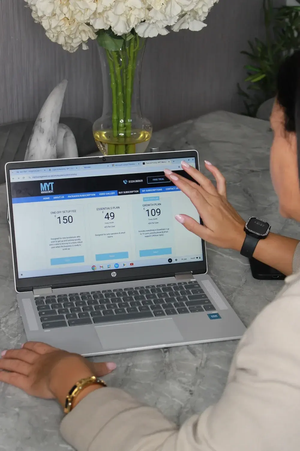 The MyT Management dashboard open on a laptop, showing job numbers at a glance